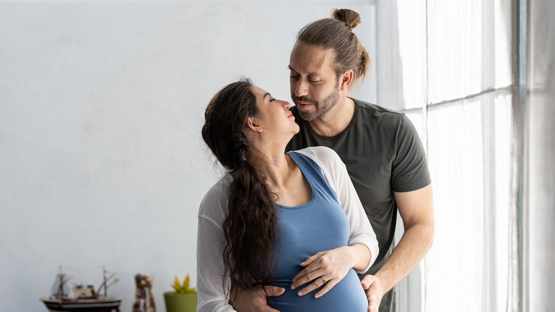 Mezczyzna i kobieta w ciazy tula sie do siebie